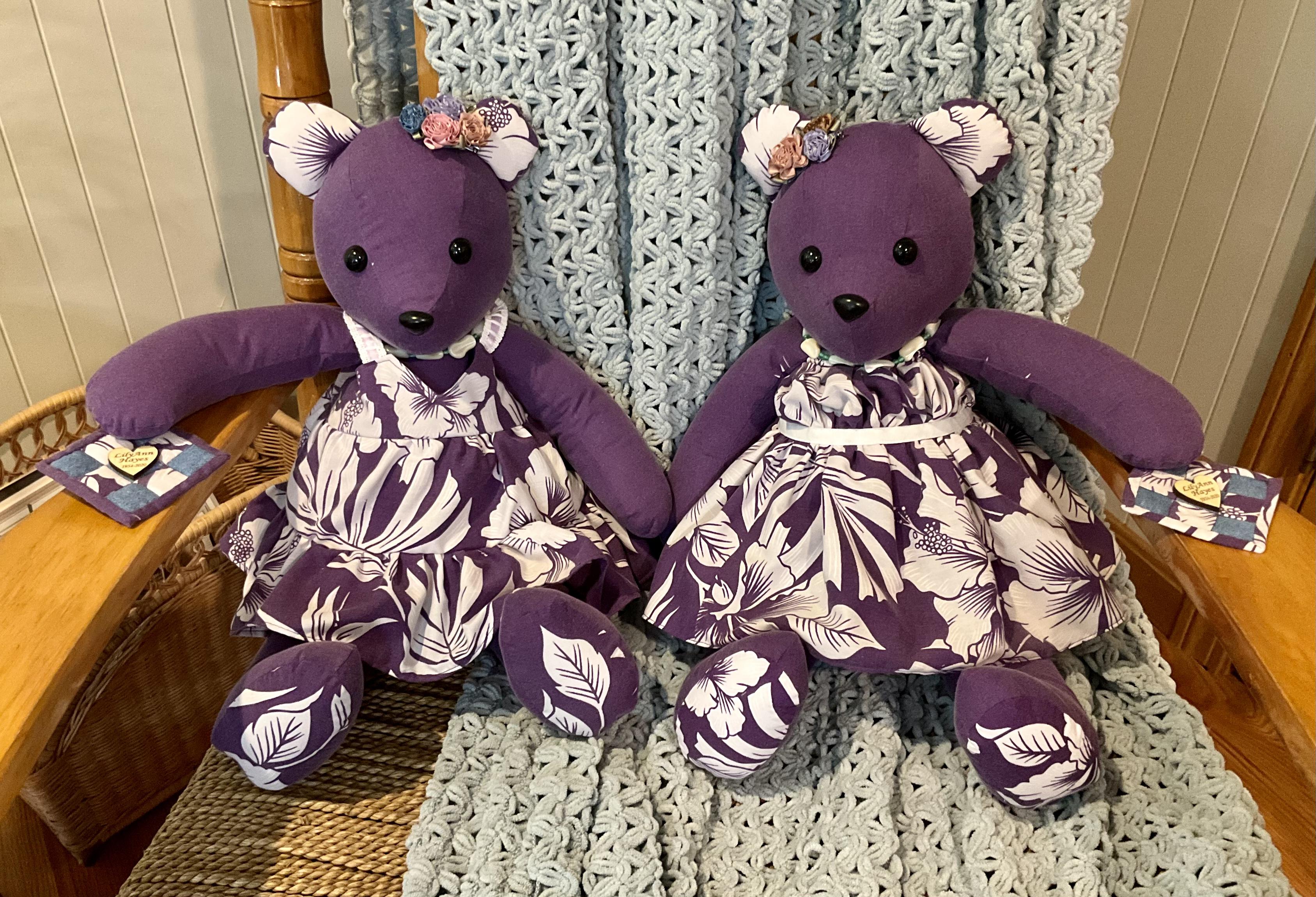 Two teddy bears sitting on a rocking chair.