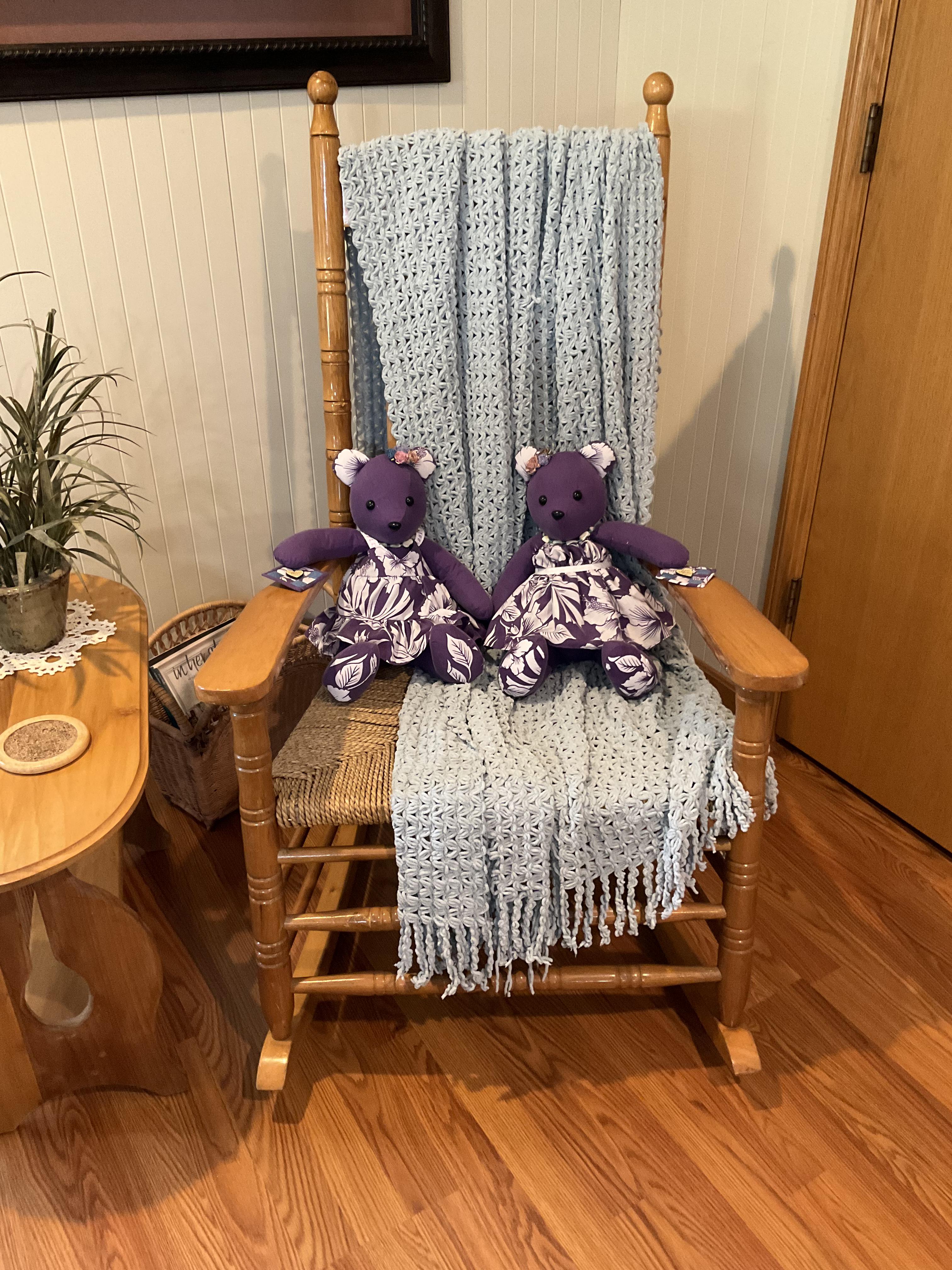 two teddy bears on a chair